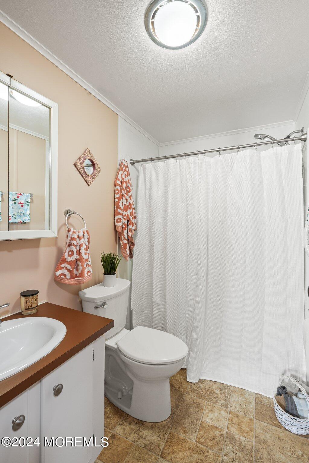 497 Rosalind Road Freehold, NJ 07728 - Photo 11 of 23 a bathroom with a sink toilet and shower
