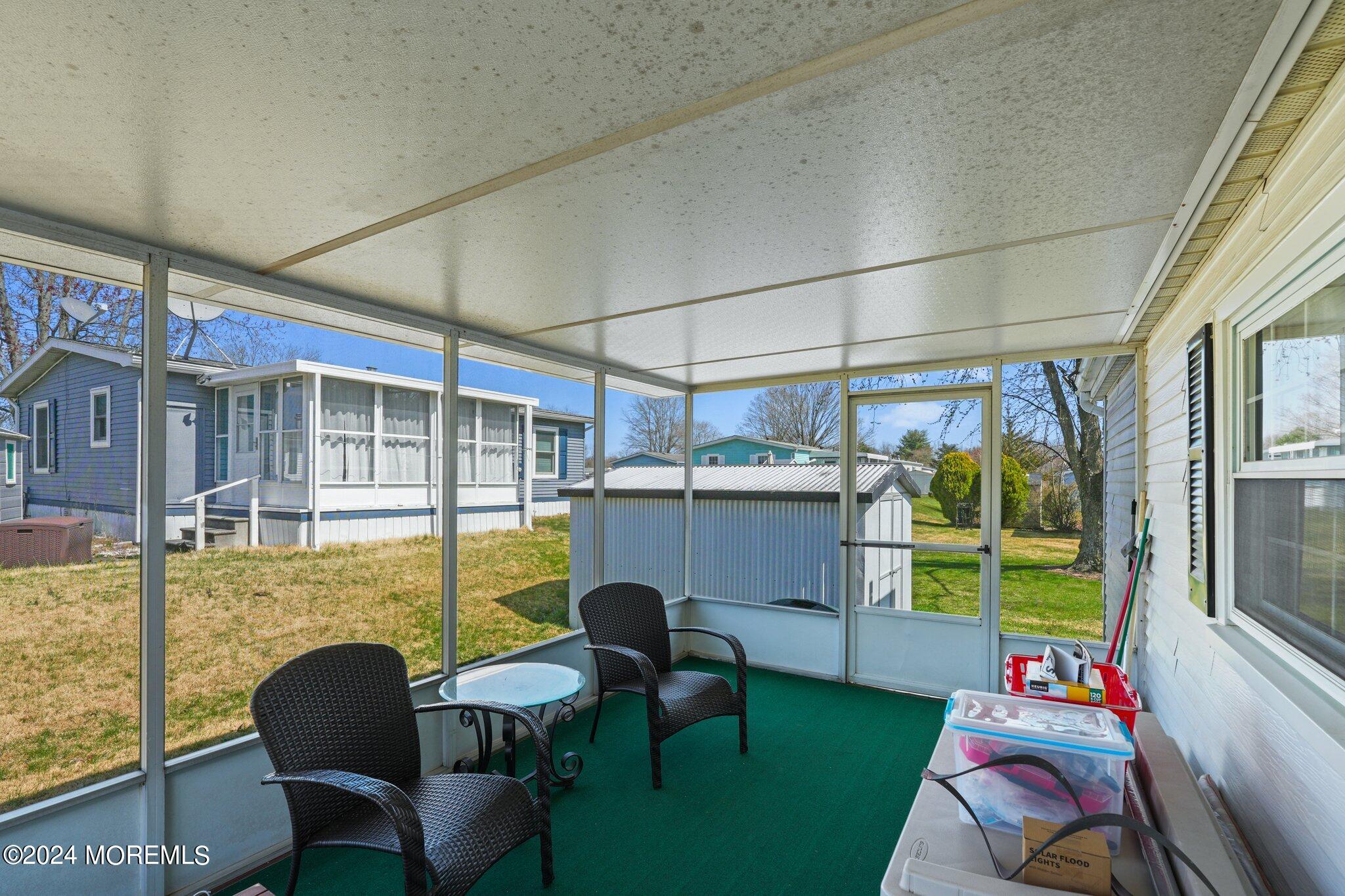 497 Rosalind Road Freehold, NJ 07728 - Photo 20 of 23 a balcony with chairs and a table