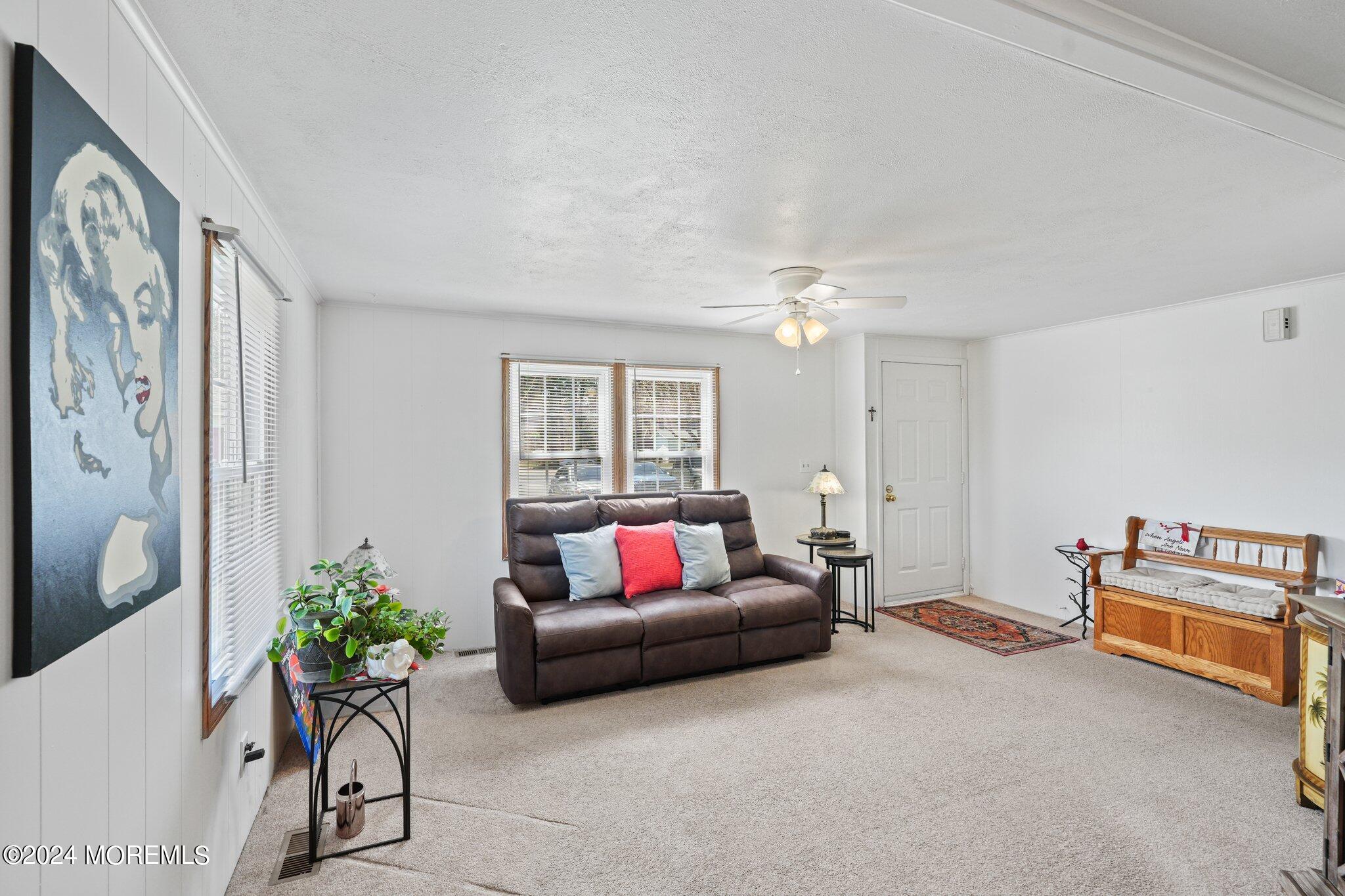 497 Rosalind Road Freehold, NJ 07728 - Photo 8 of 23 a living room with furniture and a chandelier