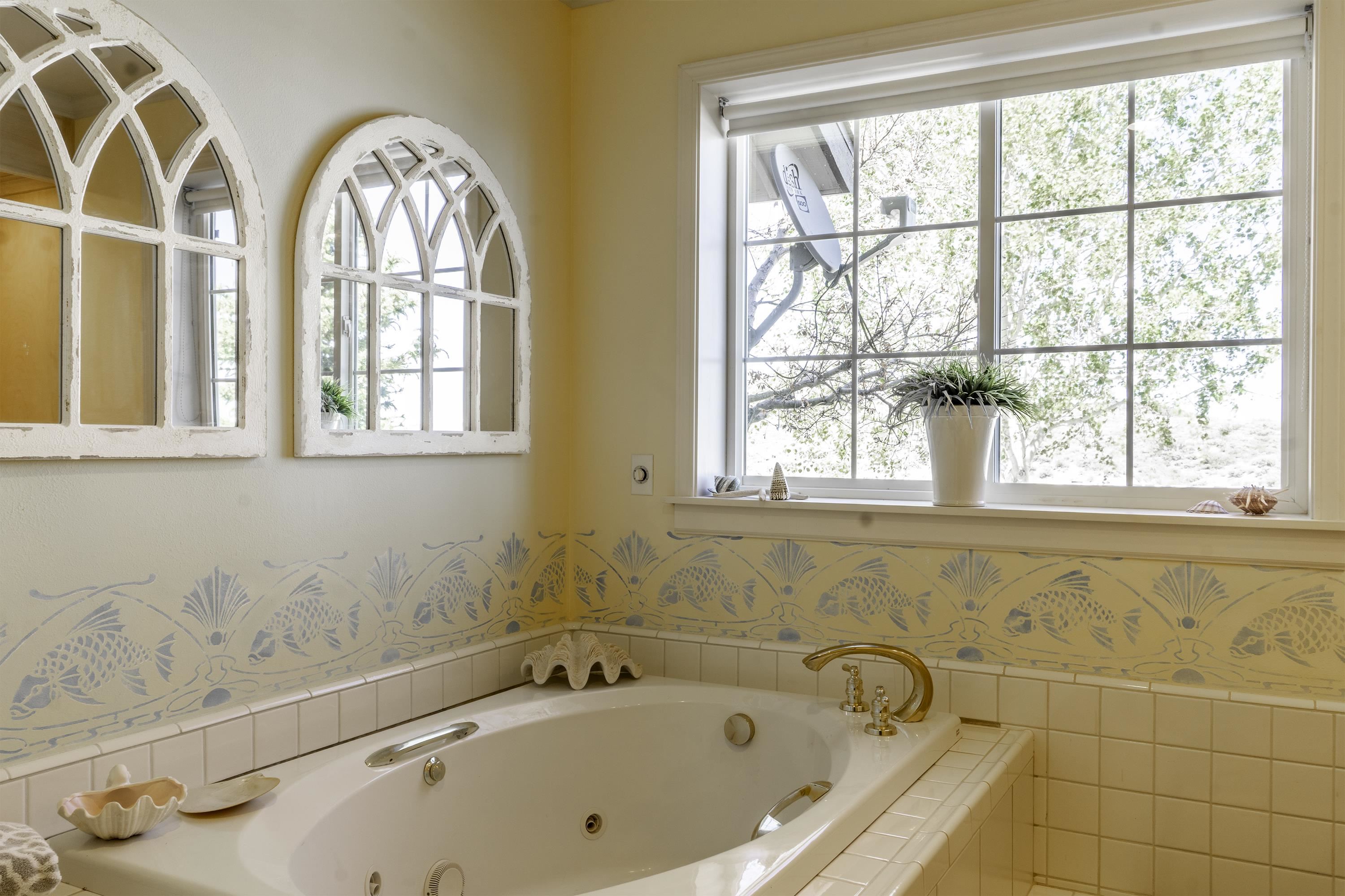 416 Wilson Creek Road Lee Vining, CA 93541 - Photo 27 of 64 a bathroom with a bathtub and a window