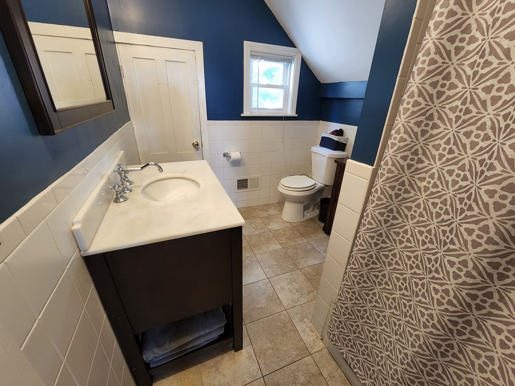 122 Walnut Street Boston, MA 02122 - Photo 14 of 17 a bathroom with a sink and a mirror