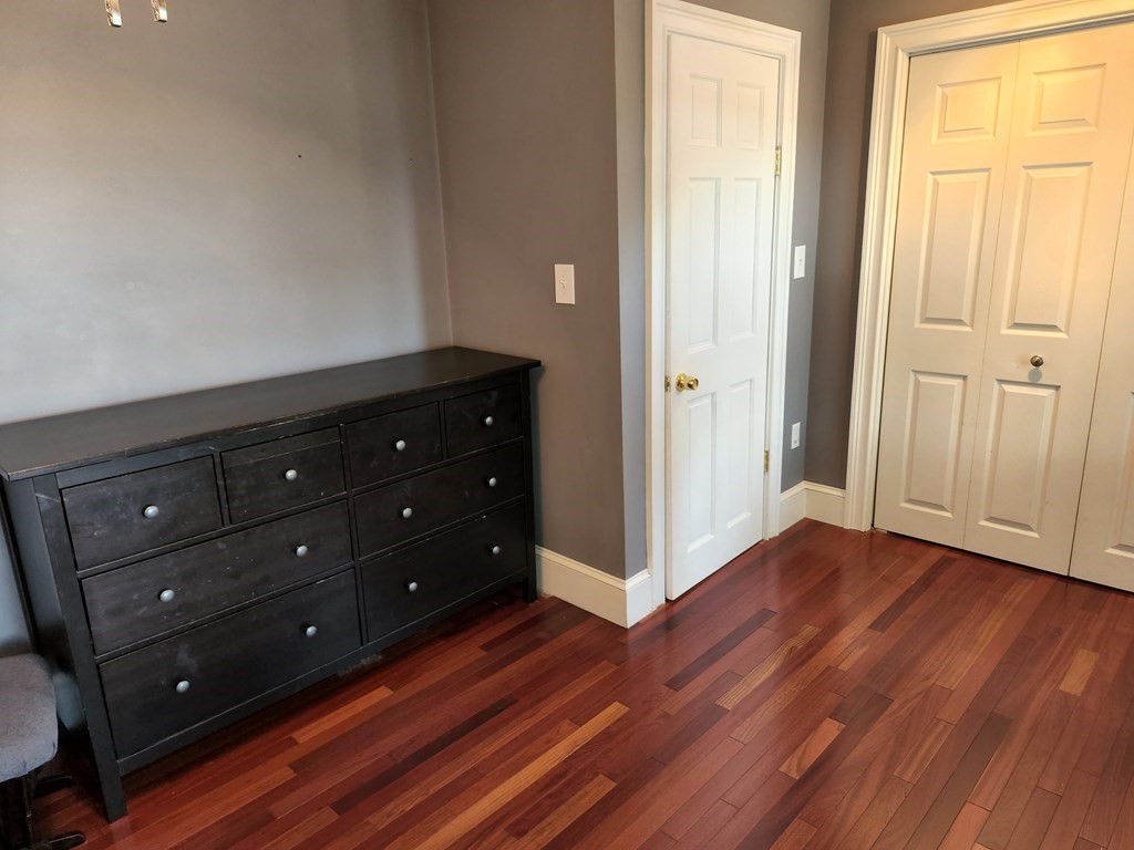 122 Walnut Street Boston, MA 02122 - Photo 15 of 17 a room with hard wood floors and a window