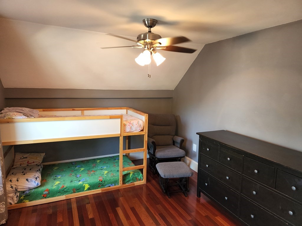 122 Walnut Street Boston, MA 02122 - Photo 16 of 17 a bedroom with a bed and a bookshelf