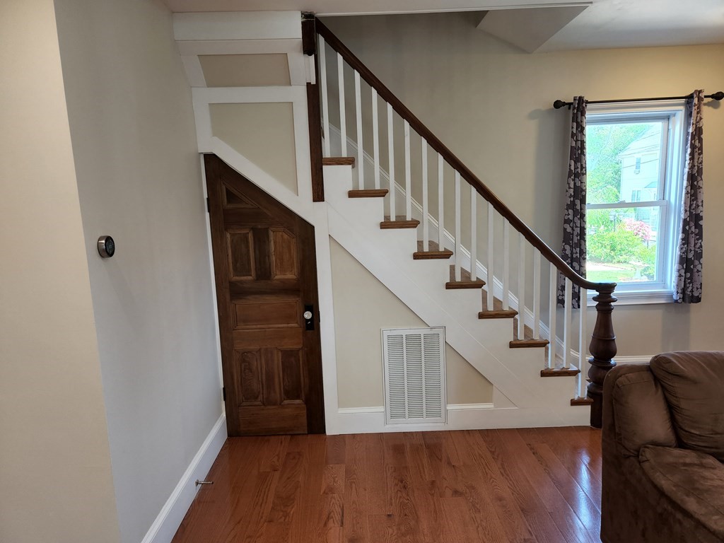 122 Walnut Street Boston, MA 02122 - Photo 17 of 17 a view of entryway with wooden floor and stairs
