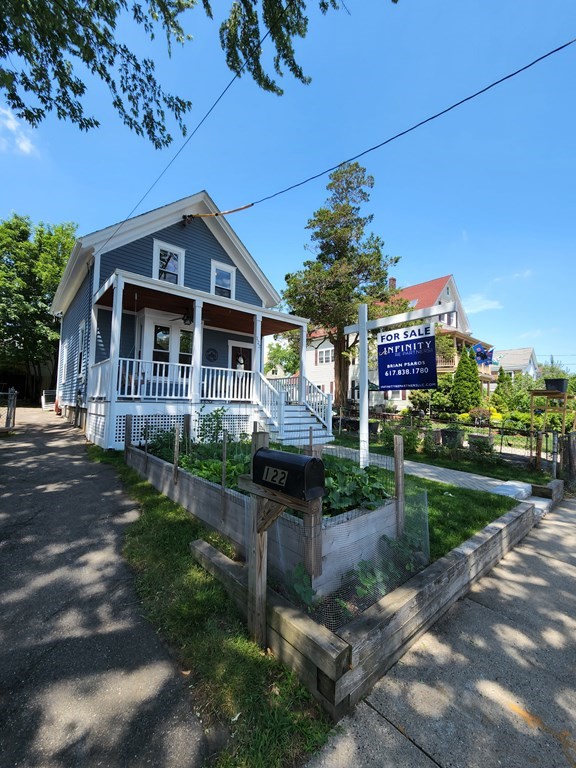 122 Walnut Street Boston, MA 02122 - Photo 4 of 17 a front view of a house with a garden and plants