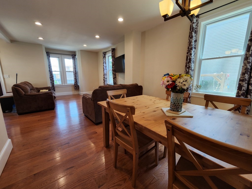 122 Walnut Street Boston, MA 02122 - Photo 7 of 17 a view of a dining room with furniture and wooden floor