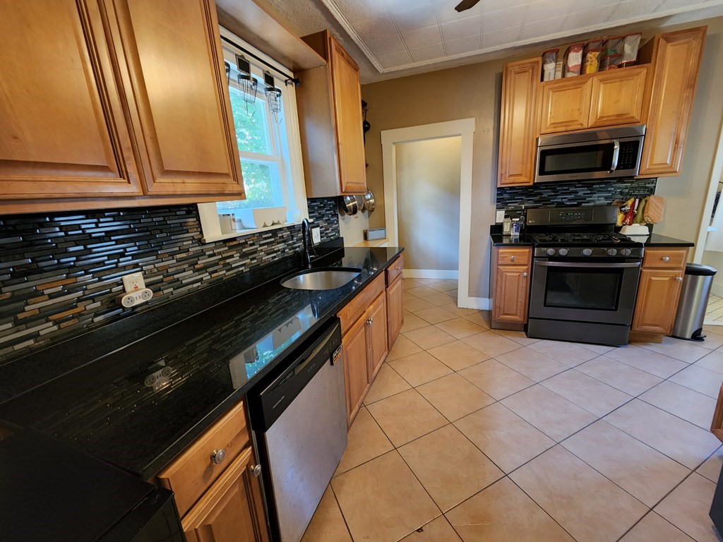 122 Walnut Street Boston, MA 02122 - Photo 8 of 17 a kitchen with stainless steel appliances a sink stove and microwave