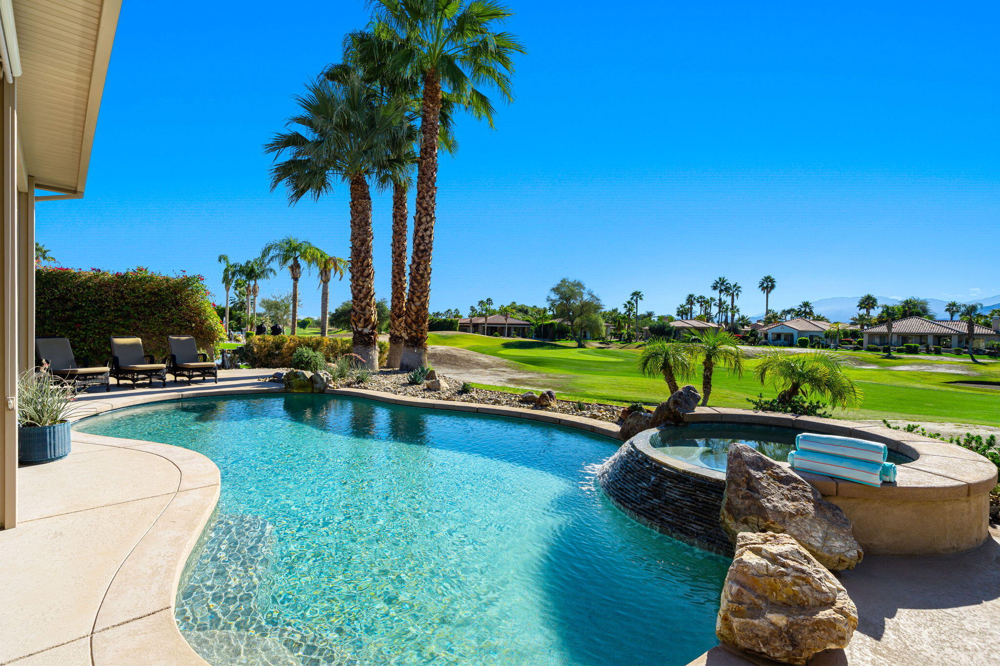96 Vía Bella Rancho Mirage, CA 92270 - Photo 1 of 60 a view of swimming pool with outdoor seating and plants