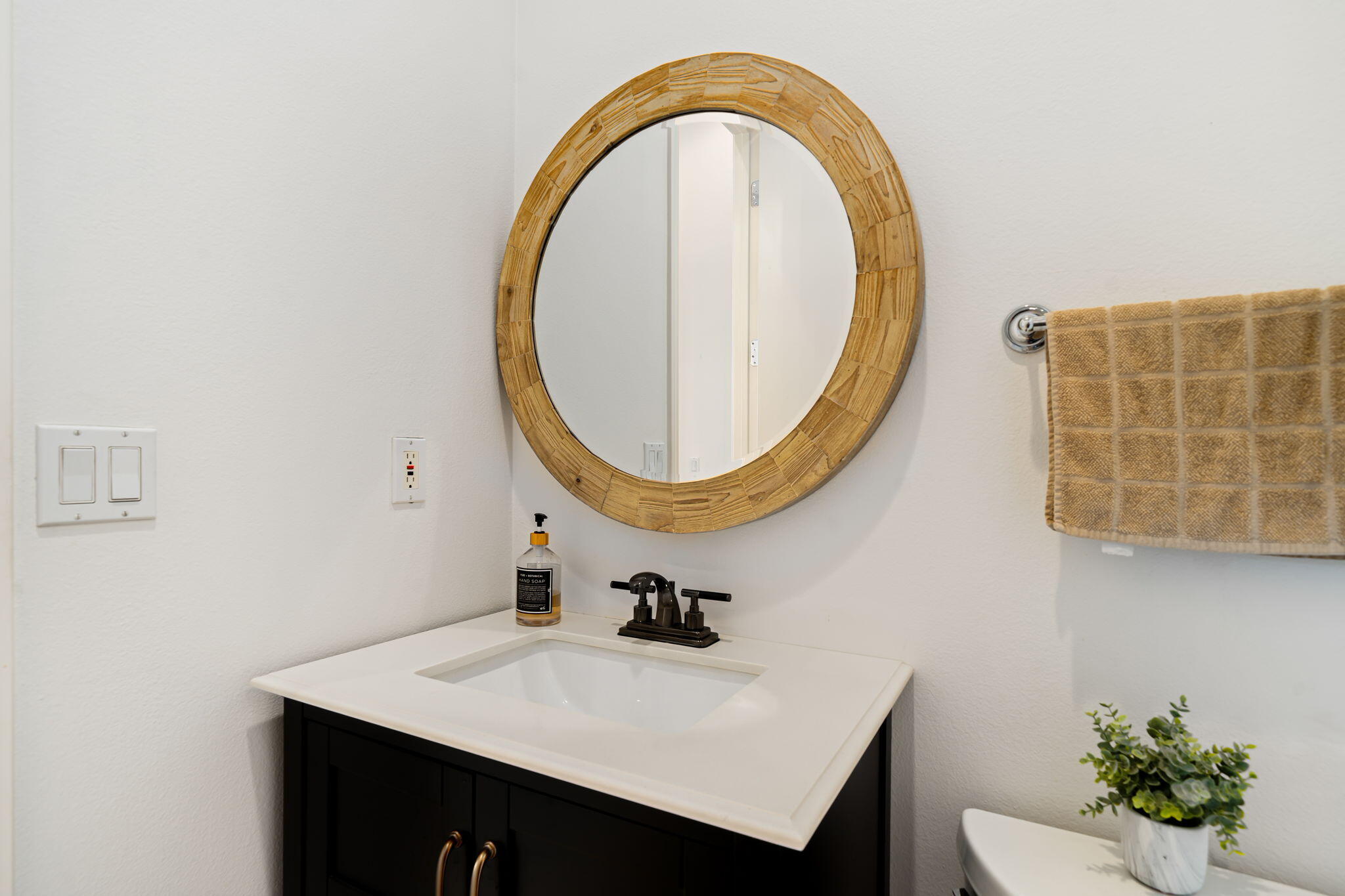 96 Vía Bella Rancho Mirage, CA 92270 - Photo 23 of 60 a bathroom with a sink a mirror and a potted plant