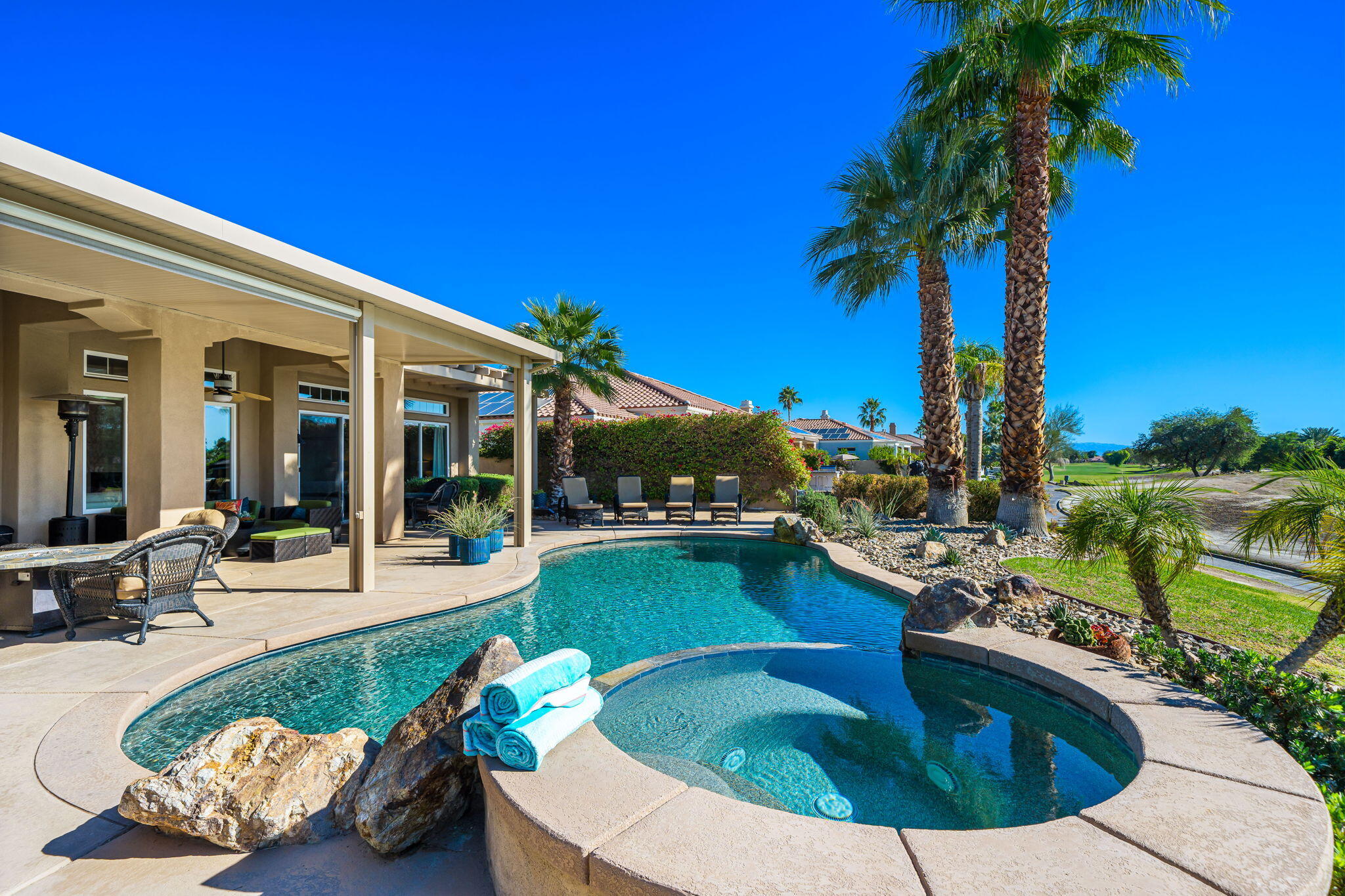 96 Vía Bella Rancho Mirage, CA 92270 - Photo 30 of 60 a view of a swimming pool with a patio and a yard
