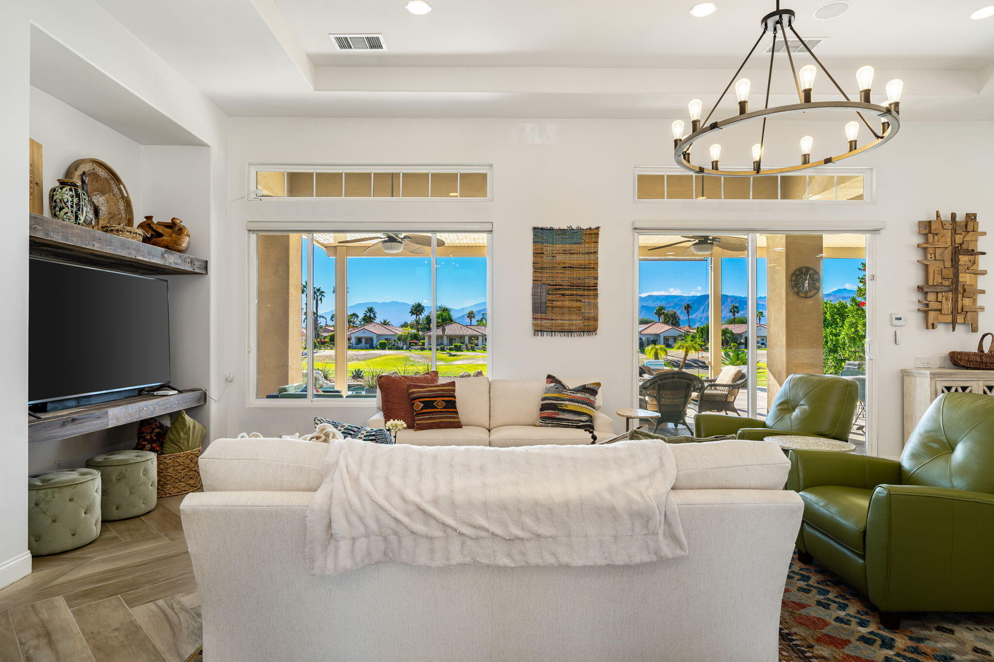 96 Vía Bella Rancho Mirage, CA 92270 - Photo 42 of 60 a living room with furniture a chandelier and a flat screen tv