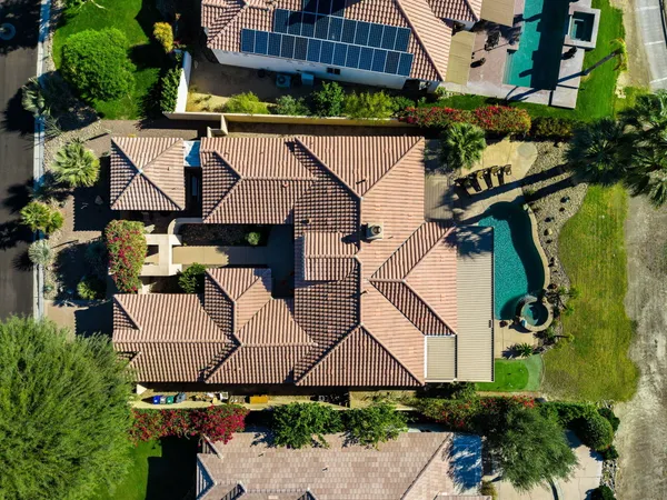 an aerial view of a house with garden space and street view