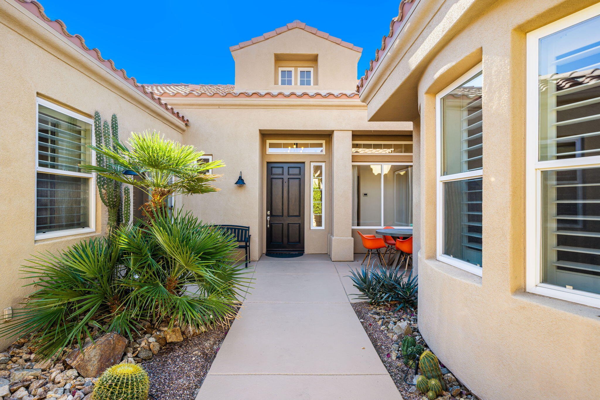 96 Vía Bella Rancho Mirage, CA 92270 - Photo 56 of 60 a front view of a house with potted plants