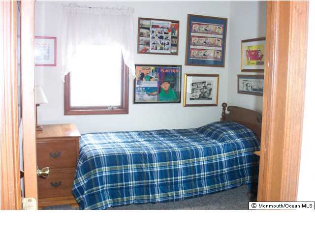 59 Spray Way Lavallette, NJ 08735 - Photo 2 of 7 a bedroom with a bed and a painting on the wall