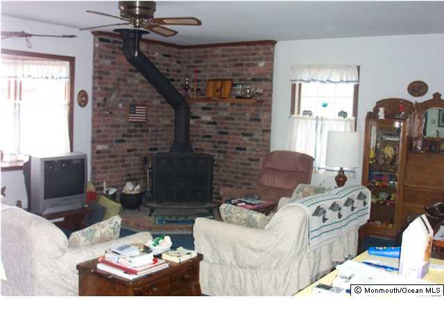 59 Spray Way Lavallette, NJ 08735 - Photo 4 of 7 a living room with furniture and a fireplace