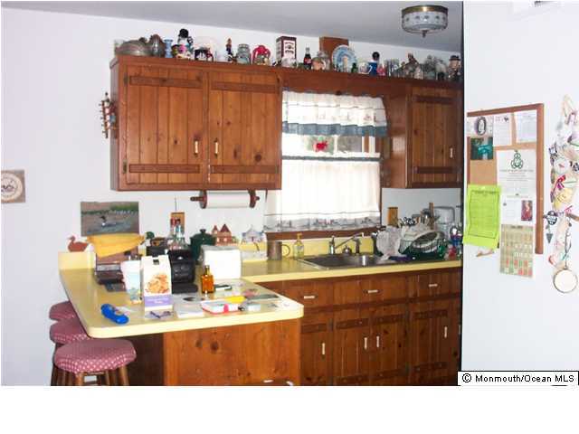 59 Spray Way Lavallette, NJ 08735 - Photo 6 of 7 a kitchen with a sink and cabinets