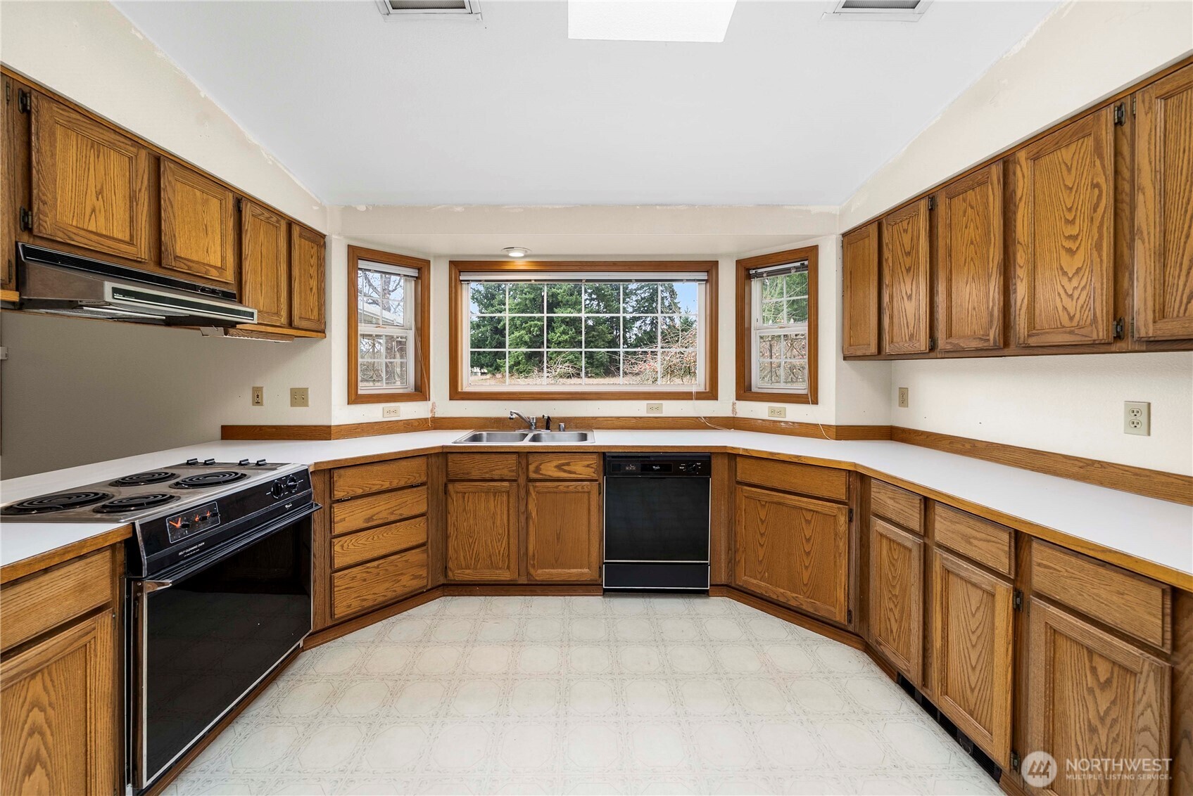 9405 Rich Road Southeast Olympia, WA 98501 - Photo 4 of 25 a kitchen with stainless steel appliances granite countertop a stove sink microwave and window