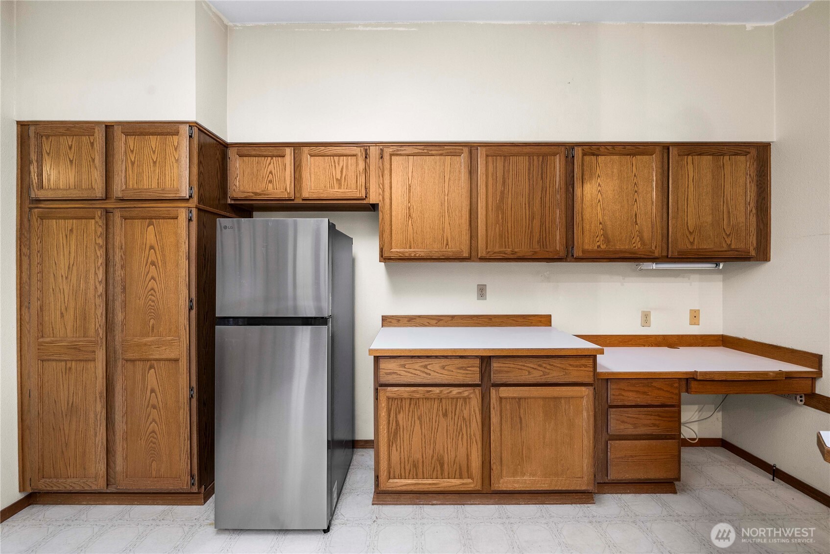 9405 Rich Road Southeast Olympia, WA 98501 - Photo 5 of 25 a kitchen with a refrigerator and cabinets