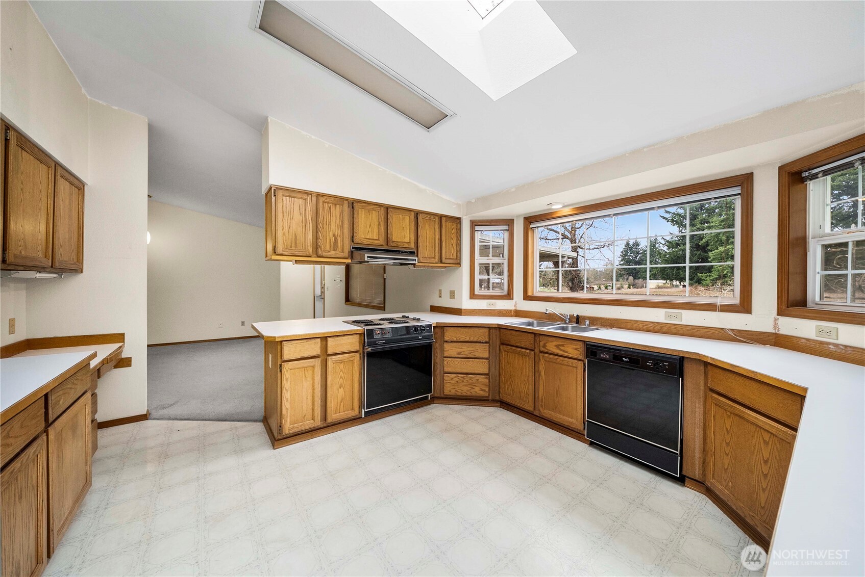 9405 Rich Road Southeast Olympia, WA 98501 - Photo 6 of 25 a large kitchen with stainless steel appliances granite countertop a stove sink and cabinets