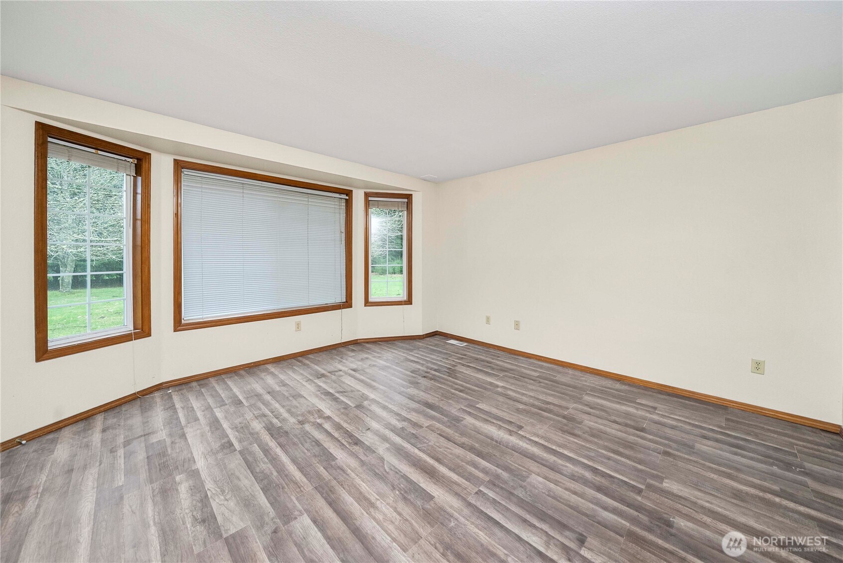 9405 Rich Road Southeast Olympia, WA 98501 - Photo 8 of 25 a view of an empty room with wooden floor and a window