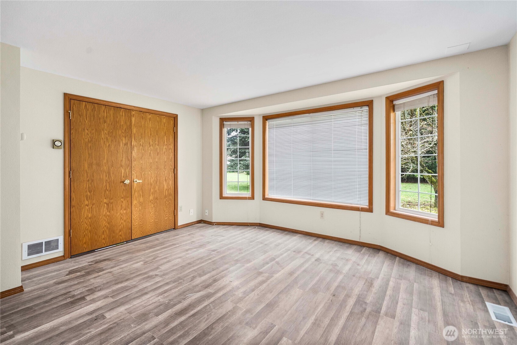 9405 Rich Road Southeast Olympia, WA 98501 - Photo 9 of 25 a view of an empty room with wooden floor and a window