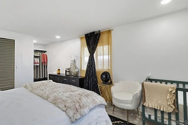 a bedroom with a bed and a dresser