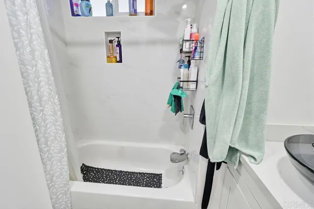 a bath tub sitting next to a white toilet