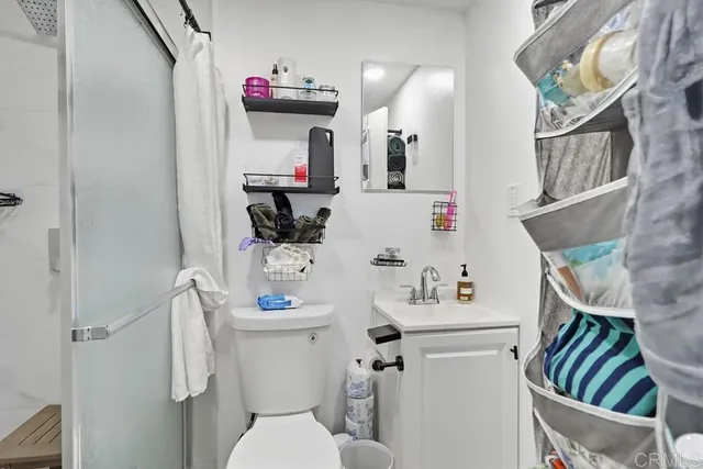 a bathroom with a sink toilet and mirror