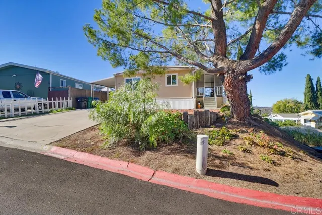 a front view of a house with street tree s