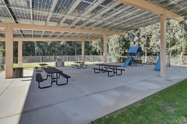 a building outdoor space with patio furniture and garden