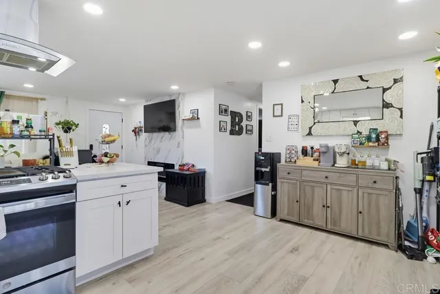 a kitchen with white cabinets and stainless steel appliances