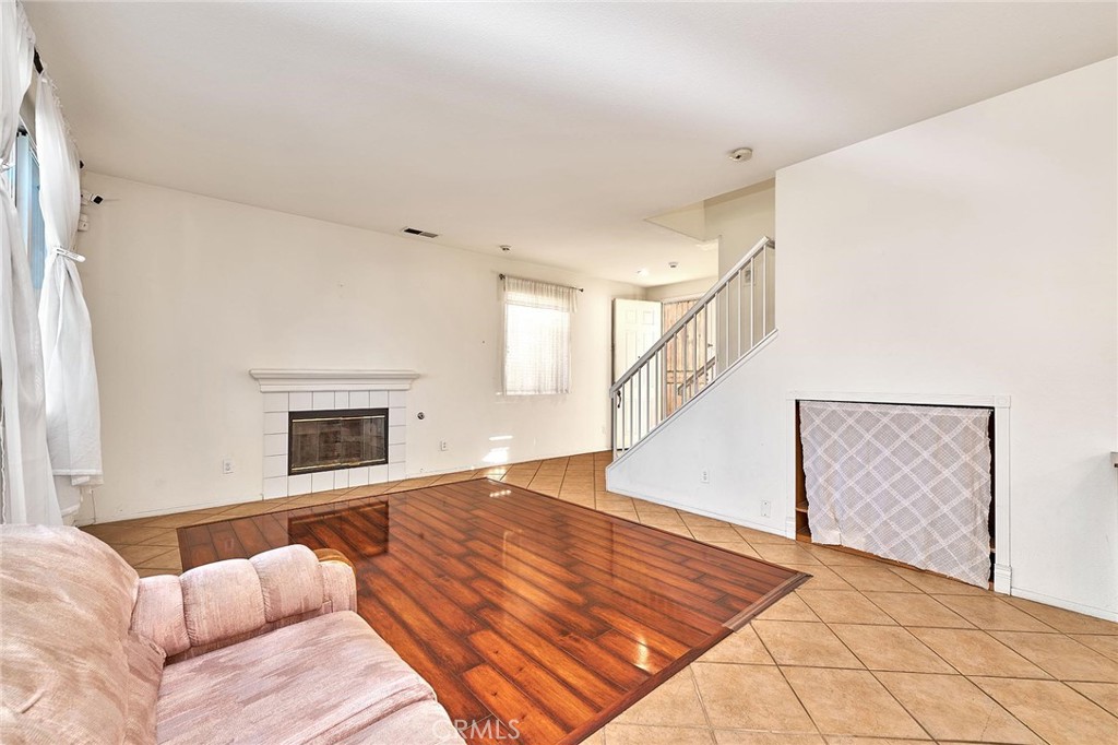 7371 Correspondence Place Rancho Cucamonga, CA 91730 - Photo 13 of 39 a view of a livingroom with wooden floor and staircase