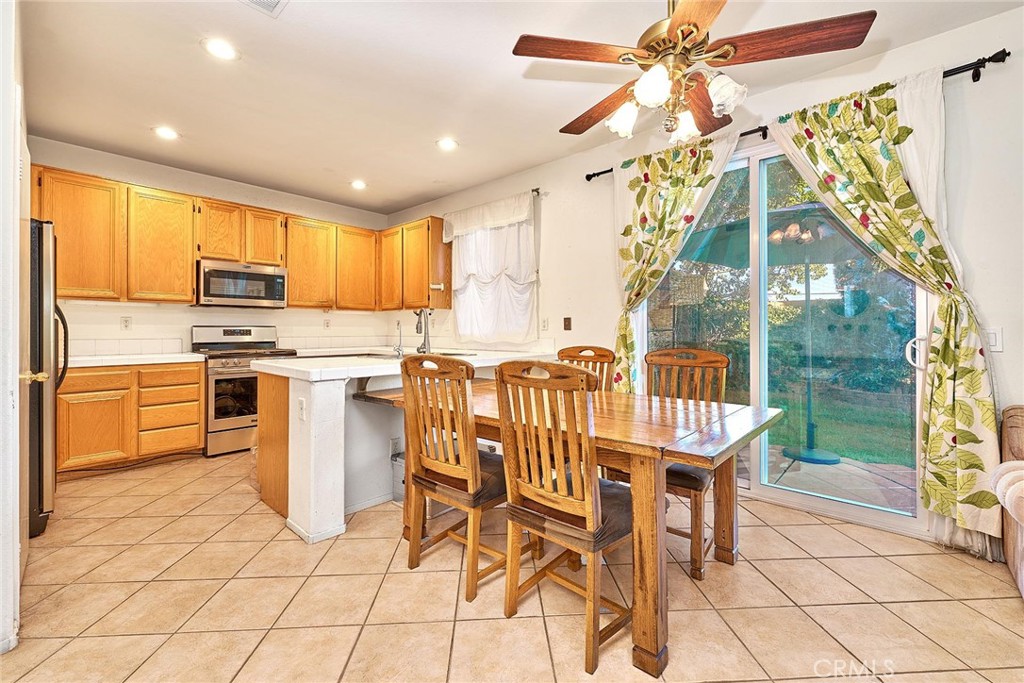 7371 Correspondence Place Rancho Cucamonga, CA 91730 - Photo 16 of 39 a kitchen with stainless steel appliances granite countertop a sink and a refrigerator