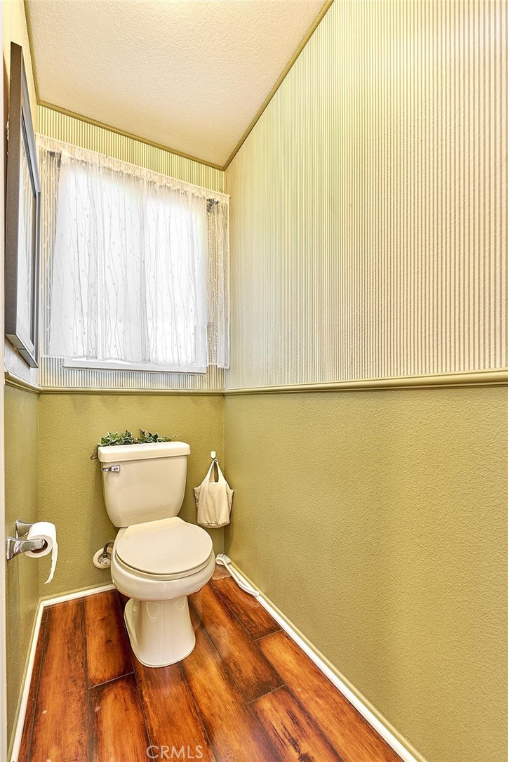 7371 Correspondence Place Rancho Cucamonga, CA 91730 - Photo 23 of 39 a bathroom with a toilet and a shower curtain