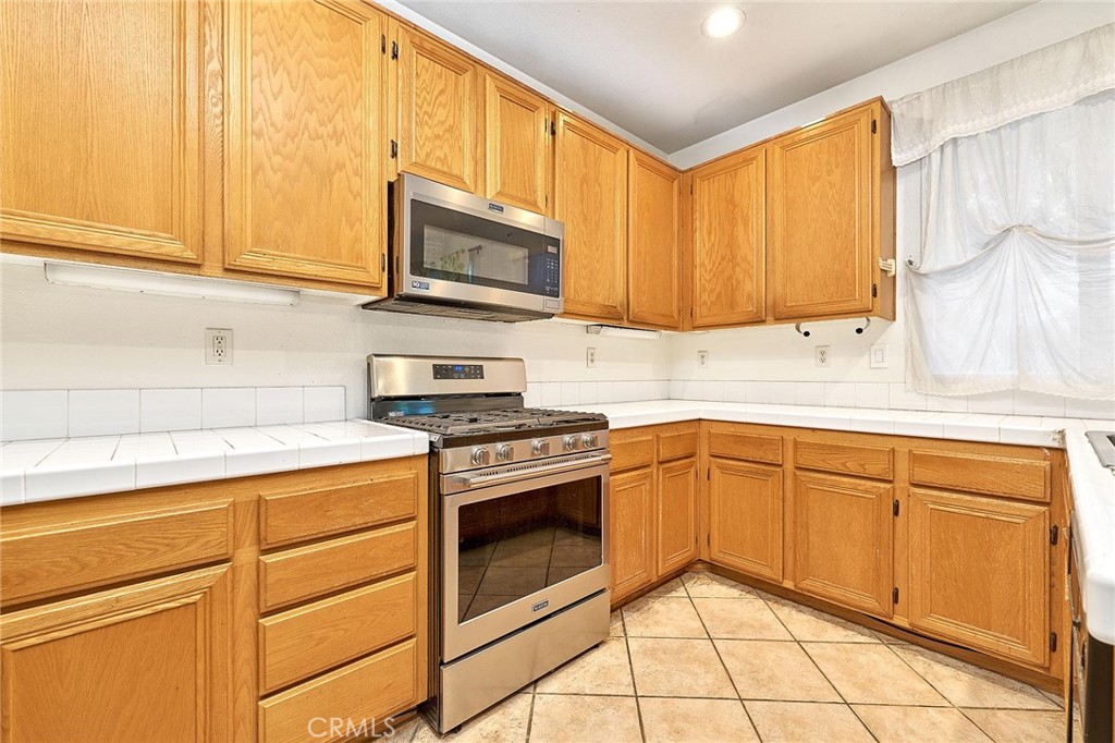 7371 Correspondence Place Rancho Cucamonga, CA 91730 - Photo 26 of 39 a kitchen with stainless steel appliances granite countertop a sink and cabinets