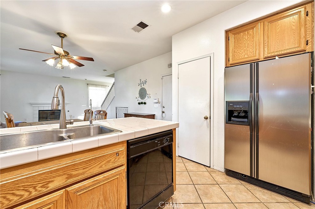 7371 Correspondence Place Rancho Cucamonga, CA 91730 - Photo 28 of 39 a kitchen with stainless steel appliances granite countertop a refrigerator a sink and a refrigerator