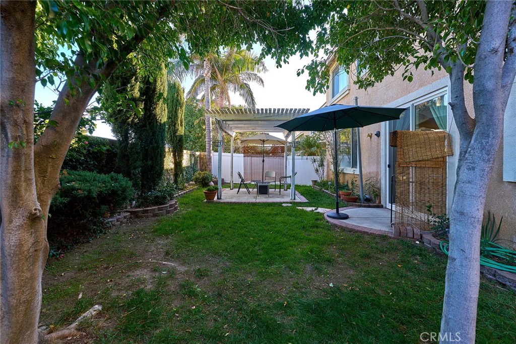 7371 Correspondence Place Rancho Cucamonga, CA 91730 - Photo 31 of 39 a view of a backyard with table and chairs potted plants and large tree