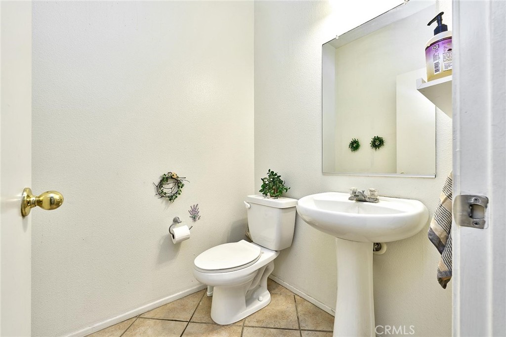 7371 Correspondence Place Rancho Cucamonga, CA 91730 - Photo 8 of 39 a bathroom with a toilet sink and mirror