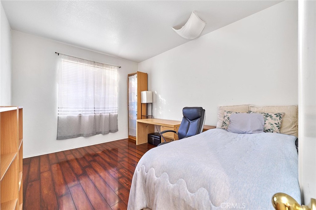 7371 Correspondence Place Rancho Cucamonga, CA 91730 - Photo 9 of 39 a bedroom with a bed and wooden floor
