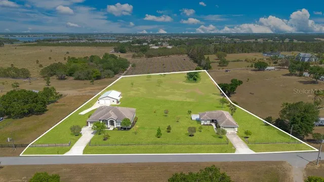 a view of an empty room with wooden floor and entryway