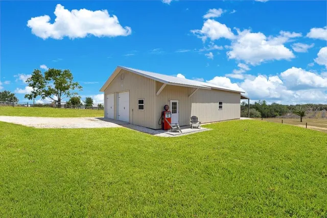 a living room with furniture and a view of kitchen