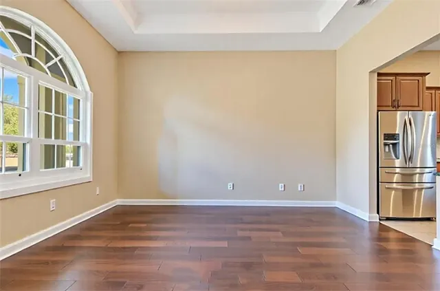 a spacious bathroom with a granite countertop sink a toilet a mirror and shower