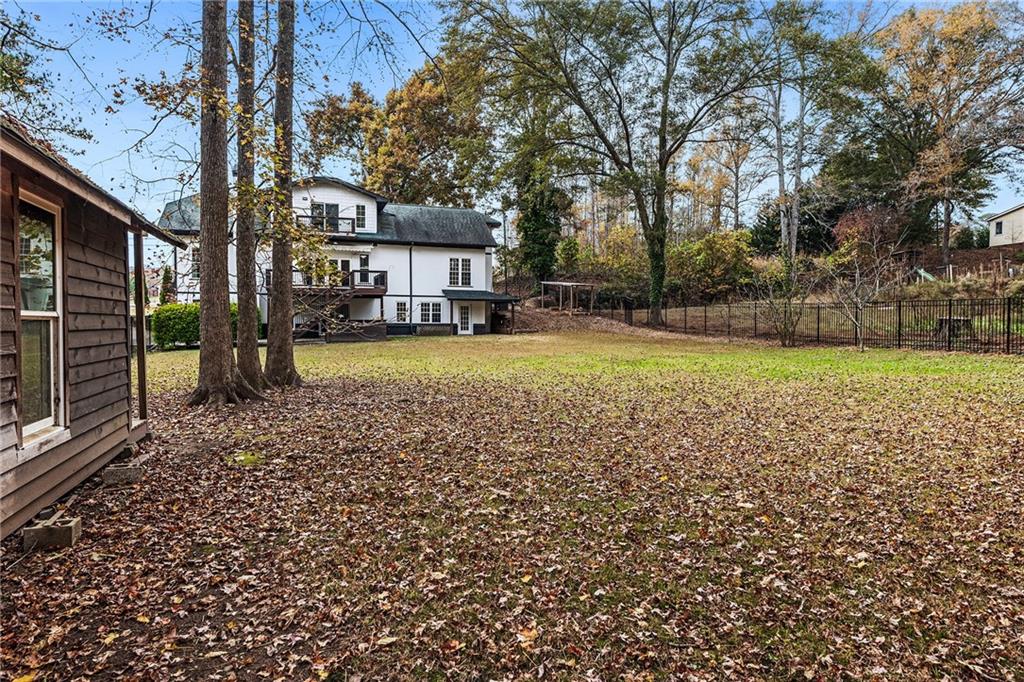 14440 Cogburn Road Alpharetta, GA 30004 - Photo 46 of 62 a view of a house with a yard and sitting area