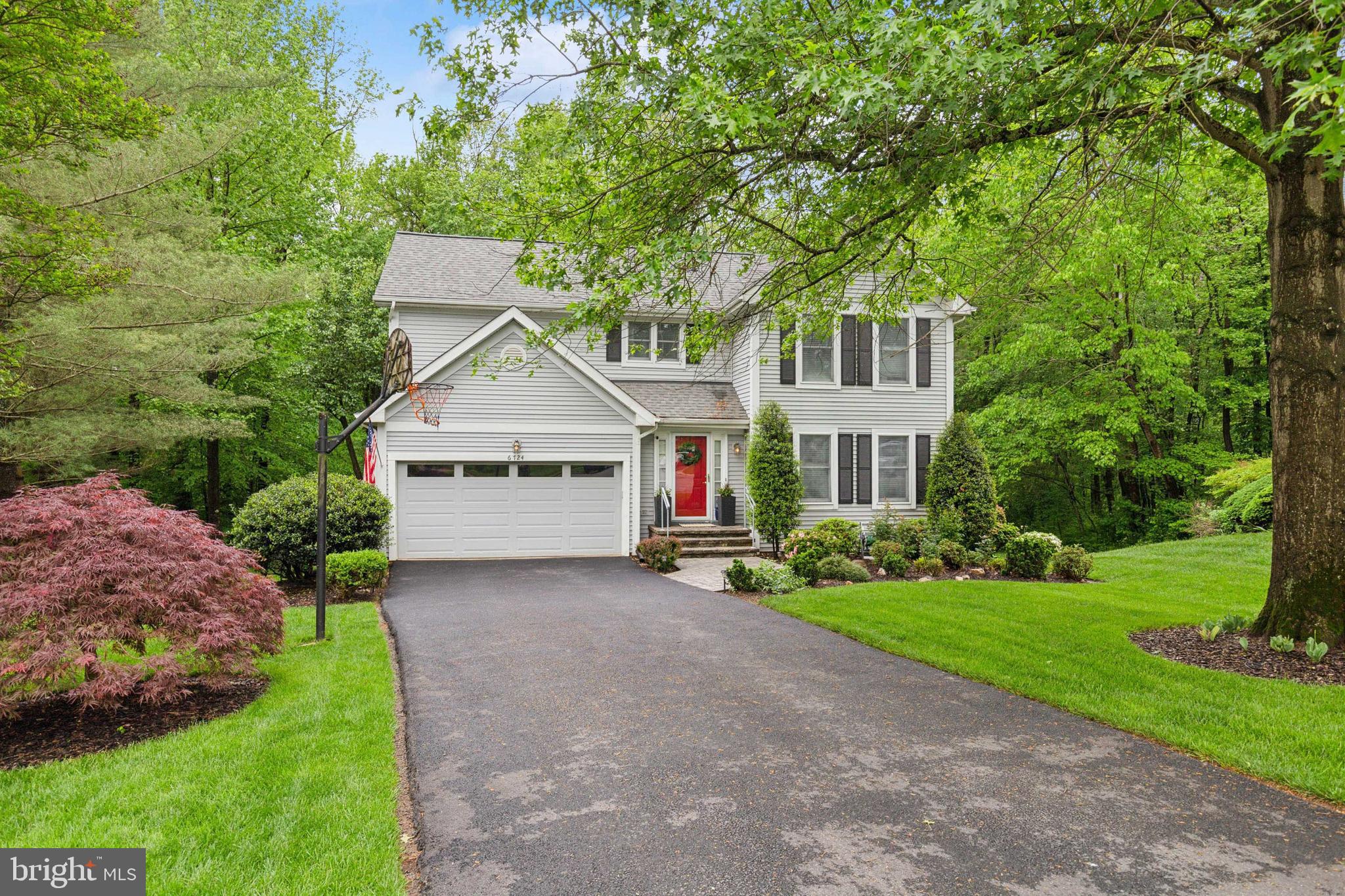 a house view with a garden and trees