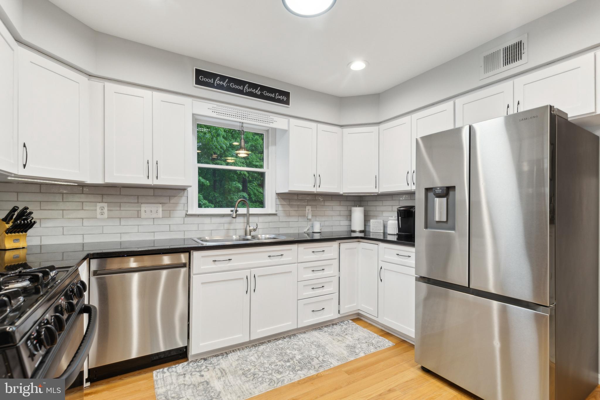 6724 Passageway Place Burke, VA 22015 - Photo 11 of 26 a kitchen with a refrigerator a sink and a stove top oven