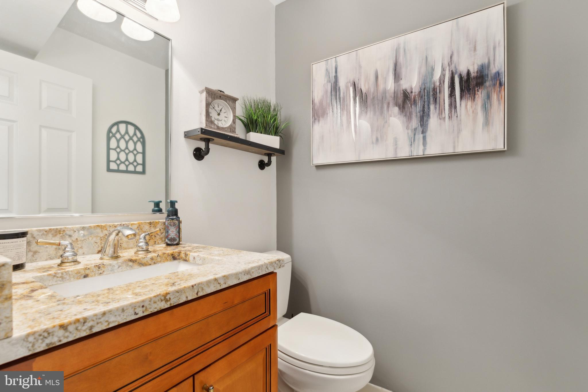 6724 Passageway Place Burke, VA 22015 - Photo 12 of 26 a bathroom with a toilet sink and mirror