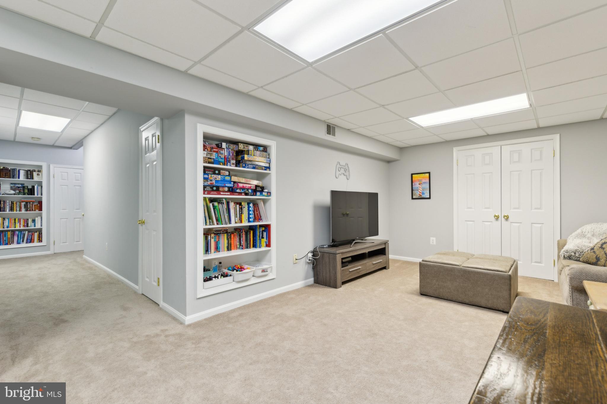 6724 Passageway Place Burke, VA 22015 - Photo 20 of 26 a living room with furniture and a flat screen tv