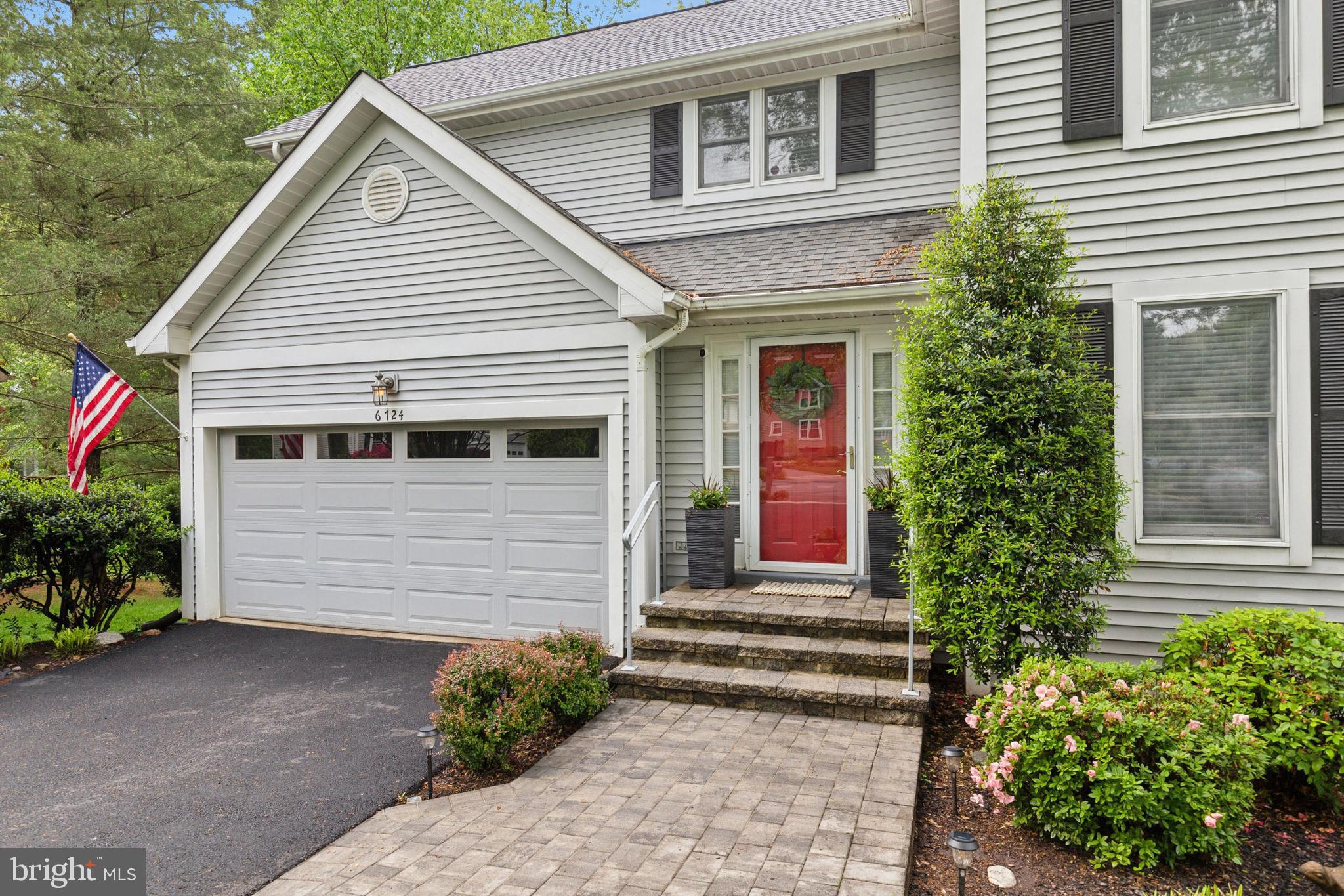 6724 Passageway Place Burke, VA 22015 - Photo 2 of 26 a front view of a house with garden