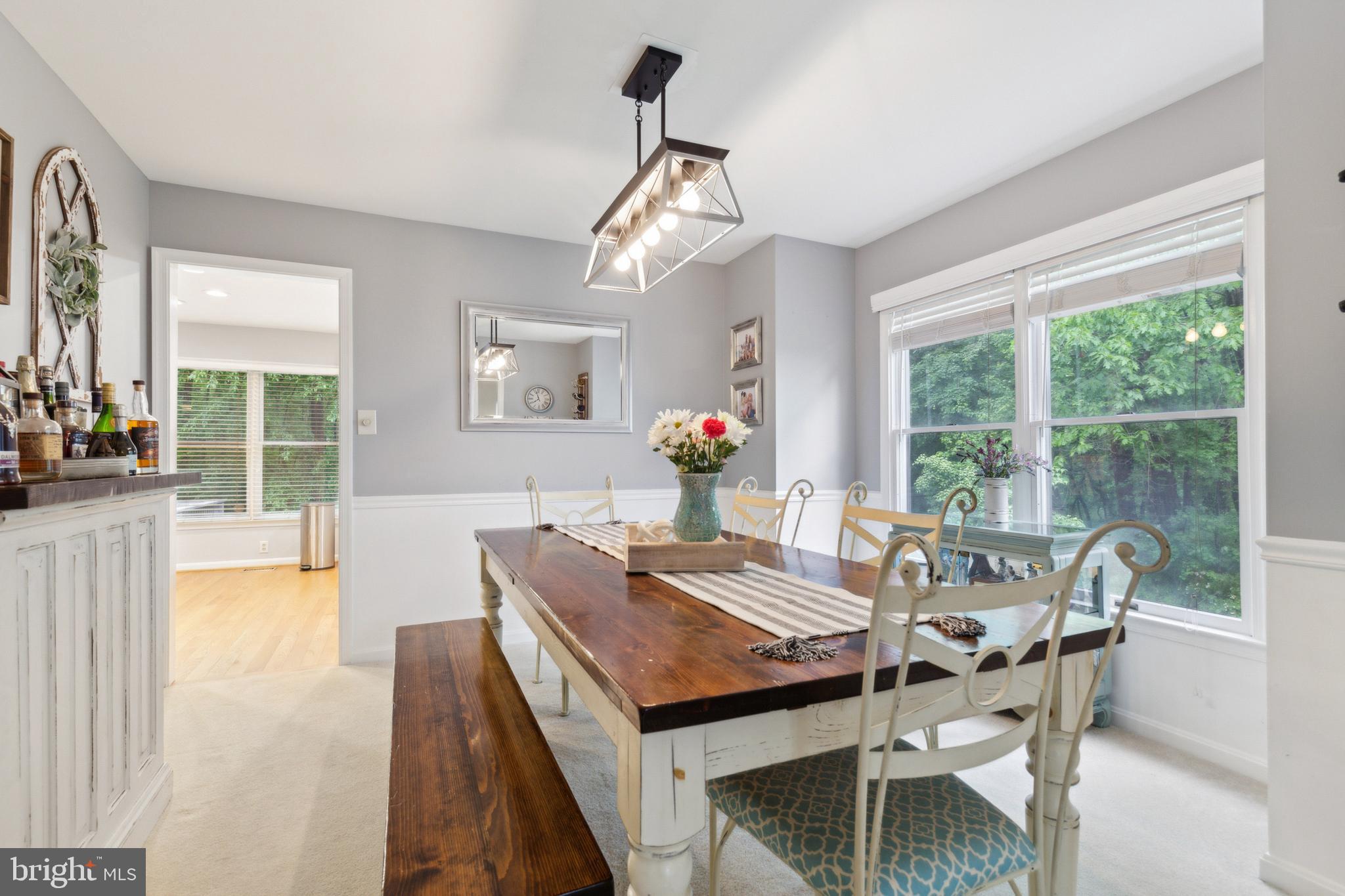 6724 Passageway Place Burke, VA 22015 - Photo 5 of 26 a dining room with furniture a chandelier and wooden floor
