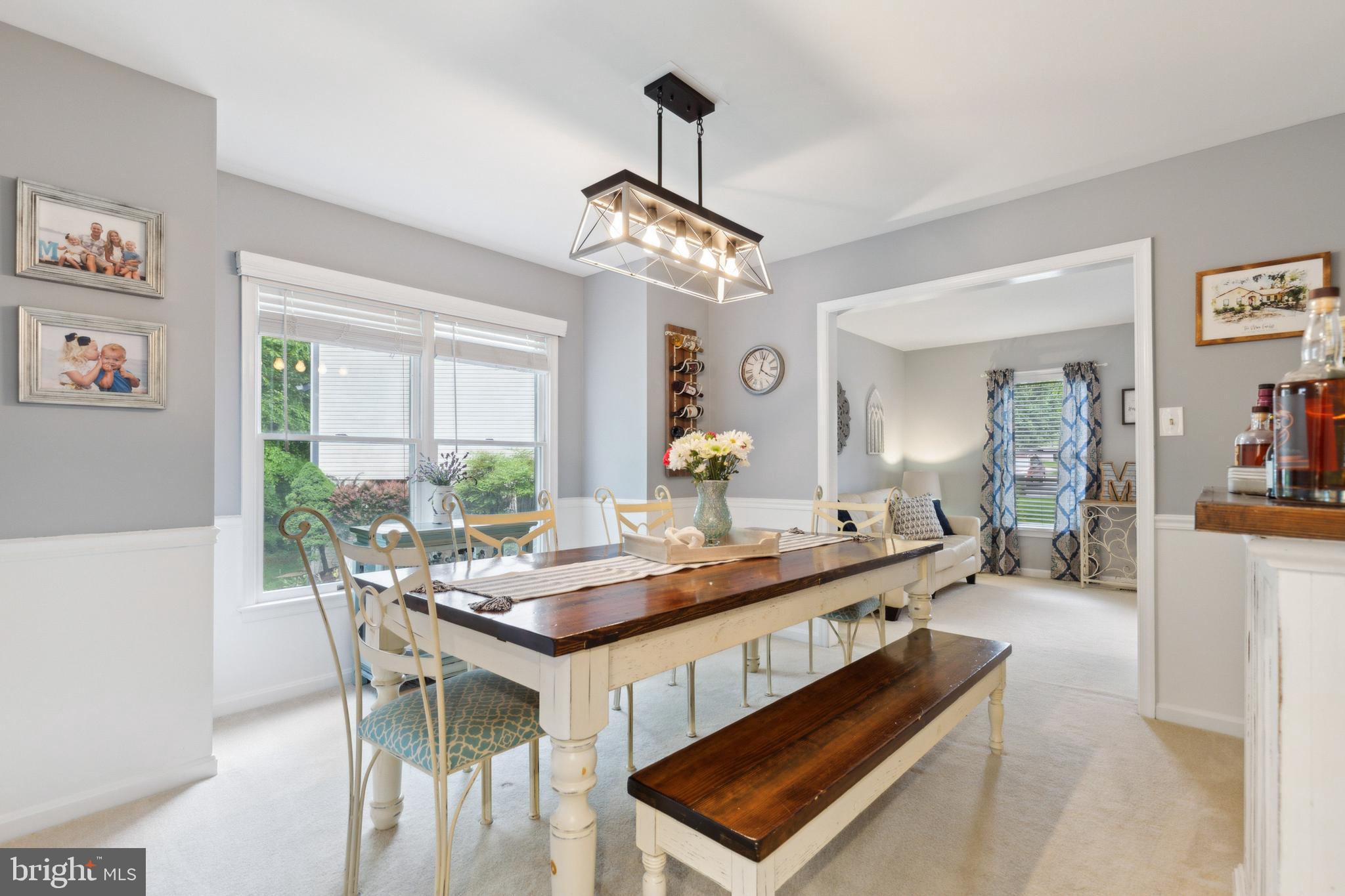 6724 Passageway Place Burke, VA 22015 - Photo 6 of 26 a dining room with wooden floor a chandelier a wooden table and chairs